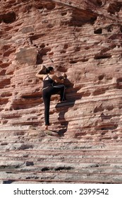 A Girl Climbing A Rock Wall In Red Rock Canyon, Nevada