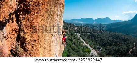 The girl climbs the rock. Climber trains on natural terrain. Extreme sport. Lessons on the street. A woman overcomes a difficult climbing route in Turkey. sports and adventure.