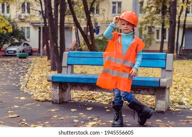 A Girl In The Clothes Of A Working Man Who Is Too Big For Her, Not In Size