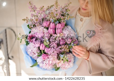 Similar – Woman makes festive bouquet with vase