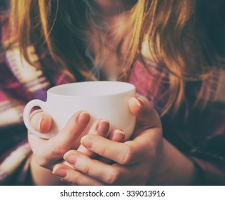 Girl with the coffee cup and plaid.