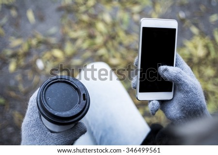Girl with coffee and mobile phone 