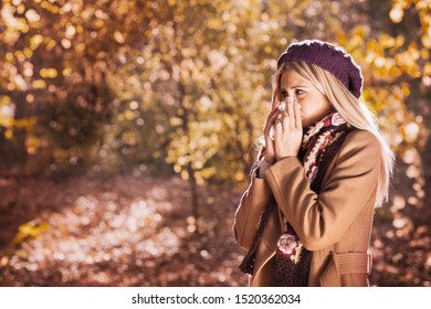 Girl With Cold Rhinitis On Autumn Background. Fall Flu Season