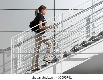A girl college student walking up the staircase