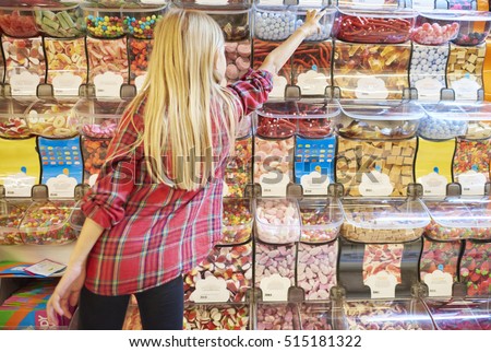 Girl and colorful candies in the background