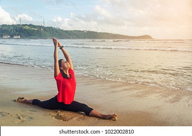 A Girl In The Colourful Dress On The Beach Is Doing Yoga, Galle, Sri Lanka