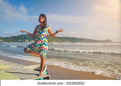 A Girl In The Colourful Dress On The Beach Is Doing Yoga, Galle, Sri Lanka