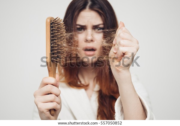 girl\
with a comb and problem hair on white\
background