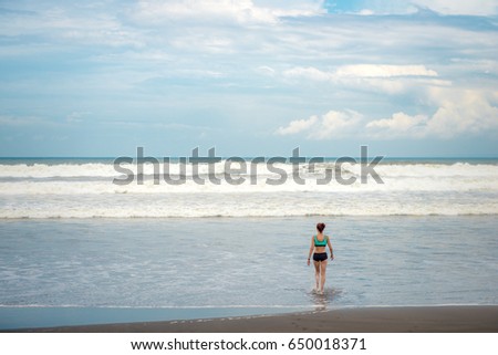 The girl comes into the ocean