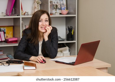 Girl At Computer Nervously Biting His Nails