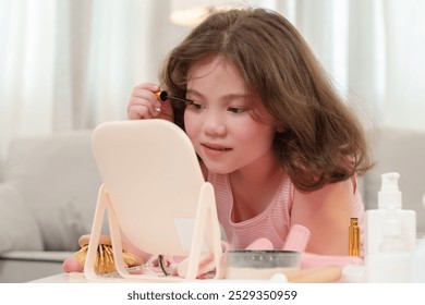 Girl concentrates while applying mascara in front of a mirror during her beauty routine. The scene captures a quiet moment of self-care and playfulness as she engages in her morning routine. - Powered by Shutterstock