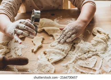 girl cook at home cookies. in a kitchen, a child stirs flour, knead the dough on the table by hand.