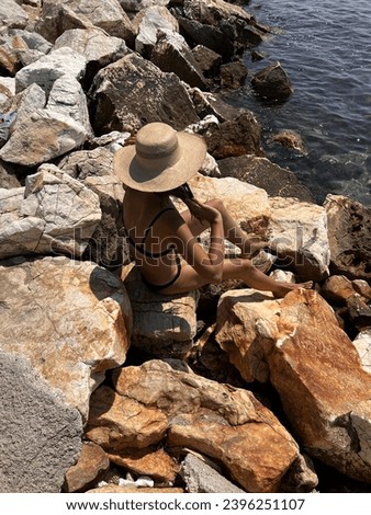 girl with a cool hat in urbaan style by the coast sea ocean in summer 