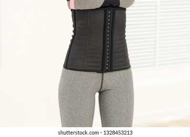 Girl In A Corset And Sports Leggings