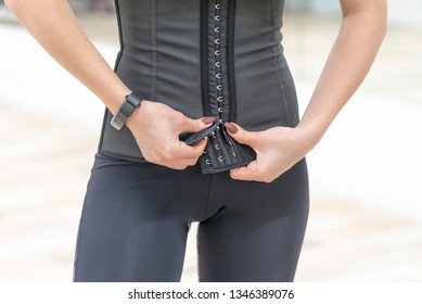 Girl In A Corset And Sports Leggings