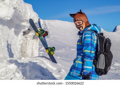 Girl In A Cougar Mask On A Snowy Slope In The Mountains