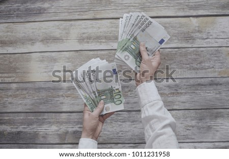 Girl counting money - one hundred euro bills