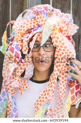 Girl covered in party streamers with a silly face