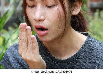 A Girl Covering Her Mouth Because Of Mouth Odour - Bad Breath Test