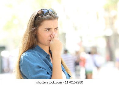 Girl Covering Her Nose Due To Bad Odour In The Street