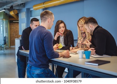 Girl At The Coworking Hub Writhing On A Paper While Colleagues Watching Her