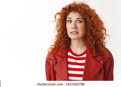 Girl cringing feeling awkward hearing strange weird confession smirking frowning look displeased uncomfortable situation standing distressed doubtful white background hesitating