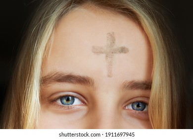 Girl With Cross Made From Ash On Forehead. Ash Wednesday Concept.