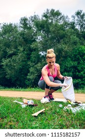 Girl Crouching With Bag Picking Up Trash Doing Plogging