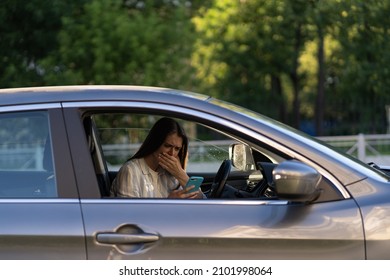 Girl Cry Reading Message In Mobile Phone. Frustrated Upset Young Woman In Tears Sit At Driver Seat In Car With Smartphone In Hand. Female Get Bad News, Breaking Up With Boyfriend In Text Sms Messenger