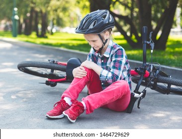 Girl Is Crying And Sitting Next To Her Bicycle, Fell Down From Bike, Got Hurt