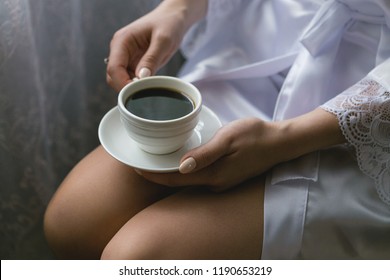 Girl with a cup of coffee on her knees close-up - Shutterstock ID 1190653219