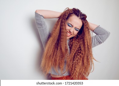 Girl With Curled Voluminous Hair, Model With Hairstyle In The Style Of The 80s. 90s, With Bright Blue Make-up. Hair Care, Brunette Red-haired Girl With Long Hair, Curling Curls, Corrugation Hair