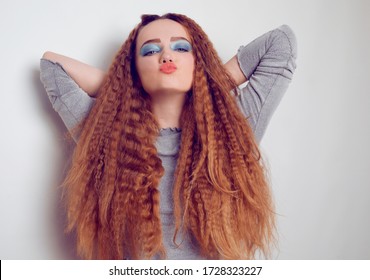 Girl With Curled Voluminous Hair, Model With Hairstyle In The Style Of The 80s. 90s, With Bright Blue Make-up. Hair Care, Brunette Red-haired Girl With Long Hair, Curling Curls, Corrugation Hair