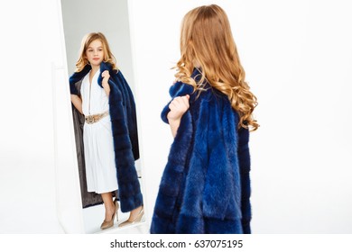 Girl With Curls Posing In Fake Fur Coat Admiring Image.