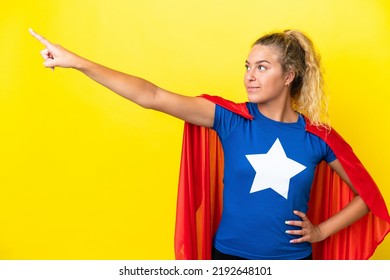 Girl with curly hair isolated on yellow background in superhero costume with proud gesture - Powered by Shutterstock