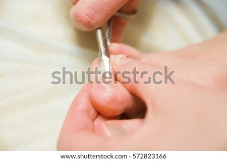 Girl cuts toenails