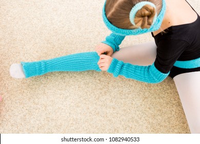 girl dancer adjusts clothes during training in dance class - Powered by Shutterstock