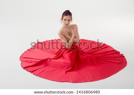
girl dancer. In a beautiful red dress in motion