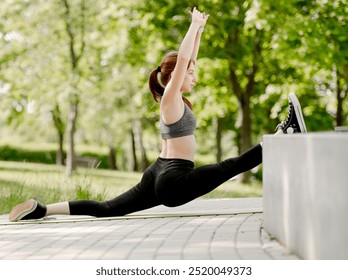 Girl Dancer Sits In Splits At Park For Warm-Up, View From Behind - Powered by Shutterstock