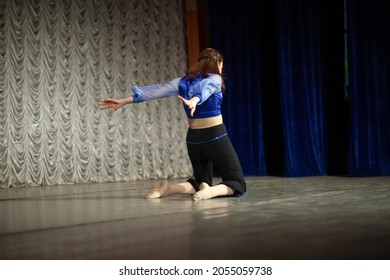 The Girl Dances On Stage. Dance Movement. Choreography Lesson. The Woman Performs Solo.