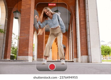 Girl dancing outdoors, concept of taking videos and creating content for social media - Powered by Shutterstock