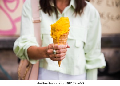 Girl With A Dark Hair Eating Italian Ice Cream Mango Flavor During Hot Summer