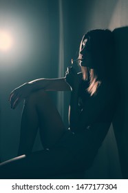 Girl in dark room with cigarette. Depression. - Shutterstock ID 1477177304