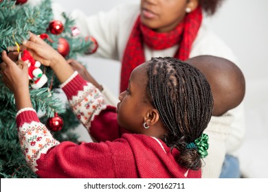 Girl Decorating The Christmas Tree