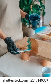 Girl Decorating A Wooden Board With Epoxy Resin Art 