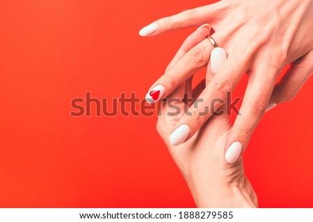 Girl demonstrates a wedding or engagement ring on her finger. Greeting card with place for text or invitation.