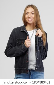 Girl In A Denim Black Jacket And Blue Denim Pants On A White Background.