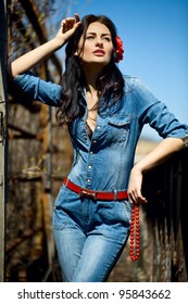 Girl In A Denim Jumpsuit With A Red Sash