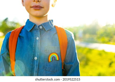 girl in denim t-shirt with rainbow symbol wear backpack in summer park outdoor - Powered by Shutterstock