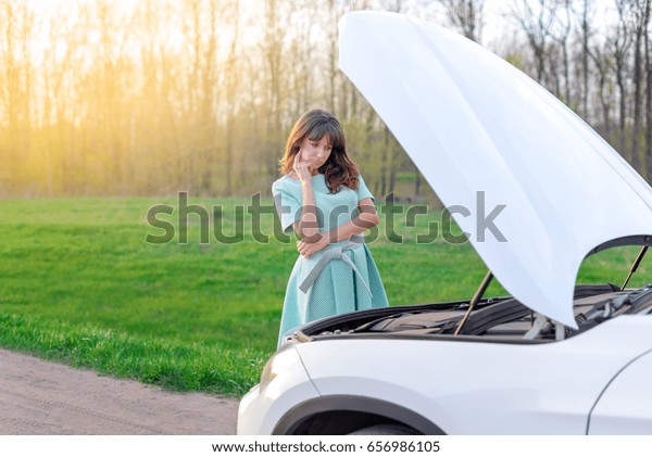 girl did not know what to do with a car that\
broke down on the road. how to solve the problem of machine\
failure. problems drivers.